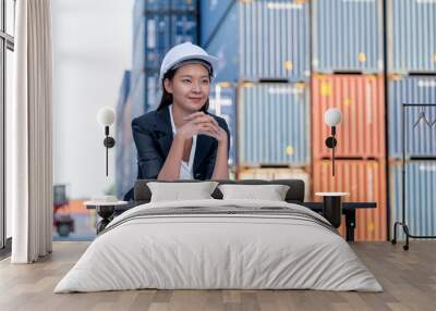 Portrait of engineer worker of factory technician with Chinese woman style sit in front of cargo container crane in workplace area. Concept of good support best successful for industrial business. Wall mural