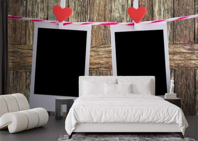 2 Blank instant photo and red clip paper heart hanging on the clothesline with old wood background.Designer concept. Wall mural