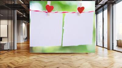 2 Blank white paper and red clip paper heart hanging on the clothesline with bokeh nature background.Designer concept. Wall mural