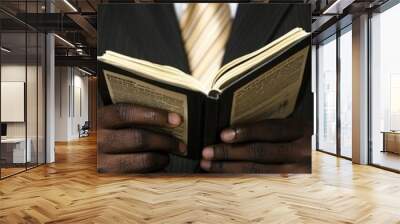 Closeup of Man s Hands Holding Open Book Wall mural