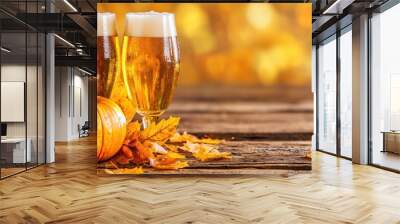 Two Glasses of Beer with Pumpkin and Autumn Leaves on Wooden Table Wall mural