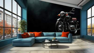 A black motorcycle with a red seat is parked in front of a dark background. The motorcycle is the main focus of the image, and it is well-maintained and shiny Wall mural