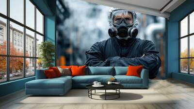 A man in a hazmat suit is standing in front of a smokestack. He is wearing a gas mask and has his arms crossed. Concept of danger and caution Wall mural