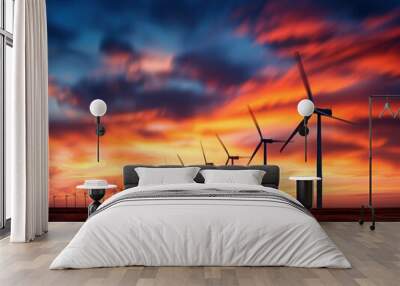 A row of wind turbines are lined up in a field, with the sun setting in the background. Concept of energy and progress, as the turbines harness the power of the wind to generate electricity Wall mural