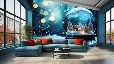 A snow globe with a house and trees inside. The scene is peaceful and serene, evoking a sense of winter wonderland Wall mural