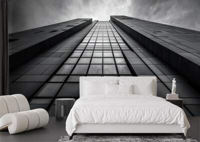 A tall building with many windows and a cloudy sky in the background Wall mural