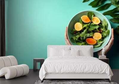 A vibrant bowl of fresh greens topped with juicy orange slices, perfect for a healthy meal. This colorful salad is a refreshing choice for any occasion. Wall mural