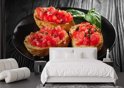 delicious Italian bruschetta with tomatoes on a black wooden rustic background Wall mural