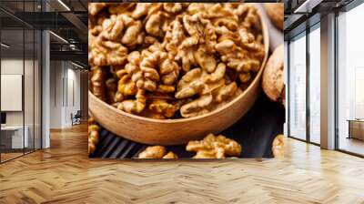 dried walnuts on a black rustic wooden background Wall mural