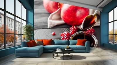 fresh pomegranate sauce narsharab on a black wooden rustic background Wall mural