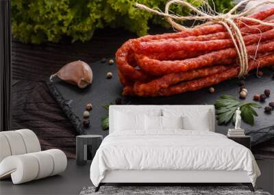 kabanos delicious polish snack sausage on a stone plate wooden background Wall mural