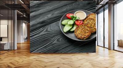 quinoa cutlet with vegetables on a black wooden rustic background Wall mural