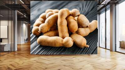 sweet and sour tamarind on a black rustic wooden background Wall mural