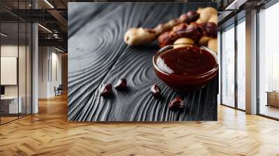 sweet and sour tamarind sauce on a black rustic wooden background Wall mural