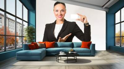 business woman,smiling to the camera,holding white card. Wall mural