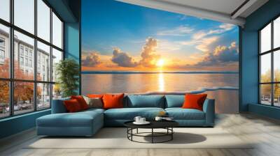 A breathtaking sunset paints the sky with vibrant hues of orange and pink as the sun dips below the horizon, casting a warm glow over a tranquil sandy beach. The gentle waves lap at the shore, creatin Wall mural