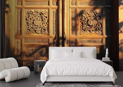 A close-up of two intricately carved wooden doors, bathed in warm sunlight. The carvings depict floral motifs and geometric patterns, creating a beautiful and intricate design. The sunlight casts long Wall mural