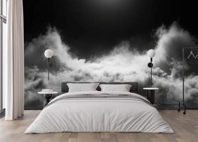 A dramatic black and white image of a dense cloud formation with a glowing light emanating from above, symbolizing mystery, hope, ethereal beauty, and a sense of the unknown. The image evokes a feelin Wall mural