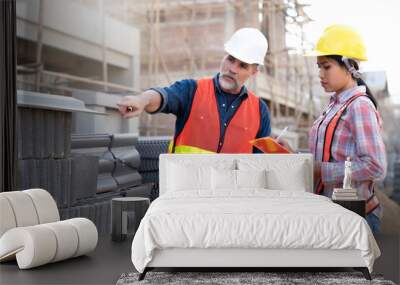 senior civil engineer inspects the bricks and roof tile at real estate project with his secretary, supplier delivers at site. Elder Engineer and Junior wearing reflective jacket and helmet for safety. Wall mural