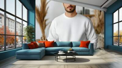 A man standing in a white long-sleeved shirt, suitable for a mockup. Wall mural