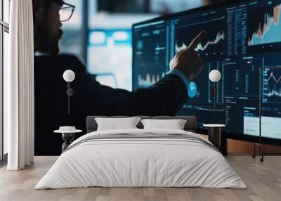 Businessman analyzing data on a large monitor in a dimly lit office Wall mural