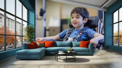 A young boy using adaptive equipment during an occupational therapy session Wall mural