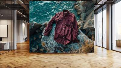 A burgundy a shirt with a simple pattern on a cliffside floor Wall mural