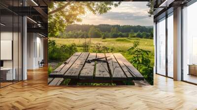 A picnic table with garden shears and a view of a meadow Wall mural