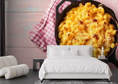 On a pink wooden backdrop homemade macaroni and cheese is cooked in a cast iron skillet Wall mural