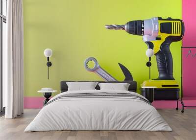 Wrench and electric drill tool on pink and lime background Wall mural