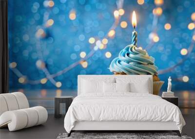 Birthday cupcake with lit candle, surrounded by blue decorations and background, birthday, cupcake, candle, blue, celebration Wall mural