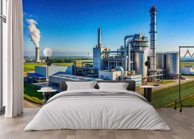 Industrial plant towering over a vast landscape under a clear blue sky , factory, industrial, manufacturing Wall mural