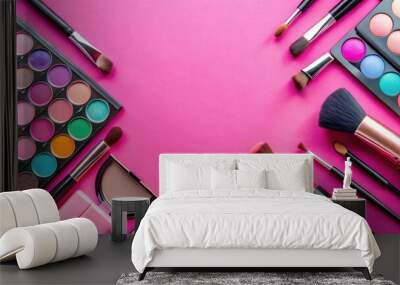 Various makeup tools and cosmetics displayed on a vibrant pink background, makeup brushes, eyeshadow palette Wall mural