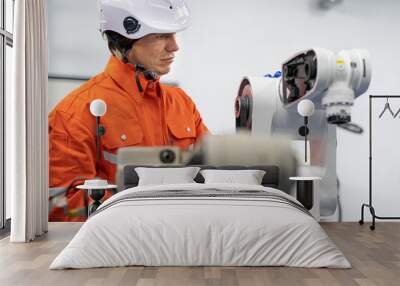 Robotic engineer examining robot power gear machine for repairing service. Modern technology technician working on hardware maintenance to repair steel and metal part of industrial automated equipment Wall mural