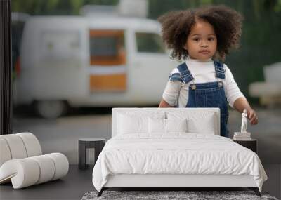 Smiling multiracial child happy walking outdoors. Portrait of cheerful multiethnic daughter enjoying carefree leisure in backyard. Cheerful kid childhood walk in park freedom expression. copy space. Wall mural