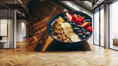 A close-up of a healthy breakfast bowl filled with fresh fruits, nuts, and yogurt, placed on a wooden table with a backdrop of natural light coming through a window Wall mural