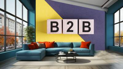 Acronym B2B- Business to Business. Wooden cubes with letters on grey and yellow background. Business Concept image. Wall mural