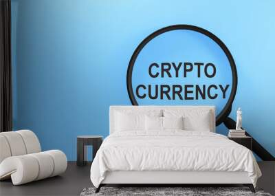 Cryptocurrency on blue screen through magnifying glass. Search of Cryptocurrency concept Wall mural