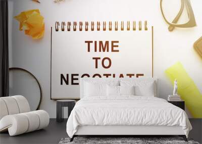 Notepad with text TIME TO NEGOTIATE, next to it lies a magnifier and glasses Wall mural