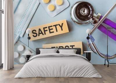 SAFETY FIRST text on a wooden blocks on a table next to a stethoscope Wall mural