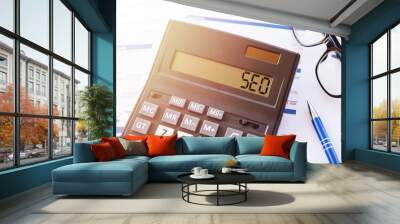 Word SEO on the display of a calculator on financial documents. Wall mural