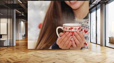 close up shot of cup in woman's hands with hot drink on Christma Wall mural