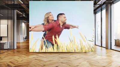 happy young couple have fun at wheat field in summer, happy futu Wall mural