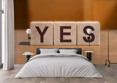 YES text on wooden cubes on orange wall background. Wall mural