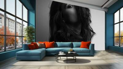 Thinking emotion thinking beautiful woman looking through long hair on dark background. Closeup portrait. Art. Black and white Wall mural