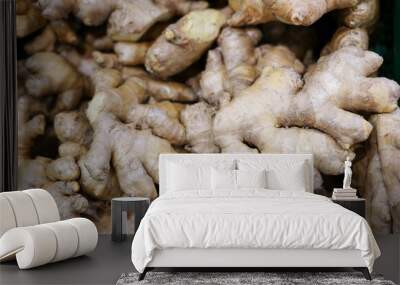 a lot of ginger in the store . A lot of Ginger Root. ginger harvest. ginger root food background. Wall mural