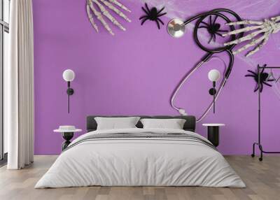 Halloween decor and stethoscope on violet background with copy space. Medical Halloween in the hospital Wall mural