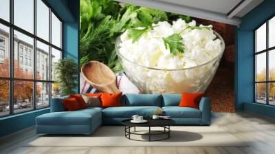 A bowl with cottage cheese, a bunch of green and rye bread Wall mural