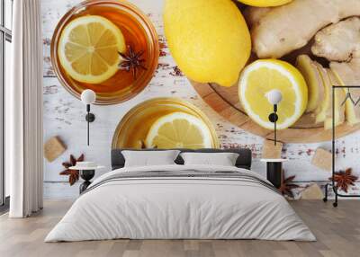 Two glass cups with hot tea with lemon and ginger Wall mural