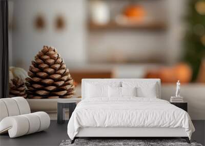 A cozy tabletop scene featuring pinecones and pumpkins, perfect for autumn and winter decor inspiration. Wall mural